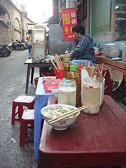 Phở gà at a typical phở street stall in Hanoi. Note the lack of side garnishes, typical of Northern Vietnamese-style phở.